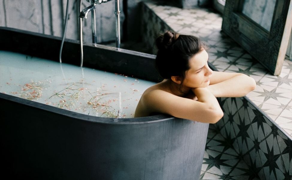 woman sitting in bathtub