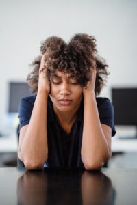 tired woman with hands in hair