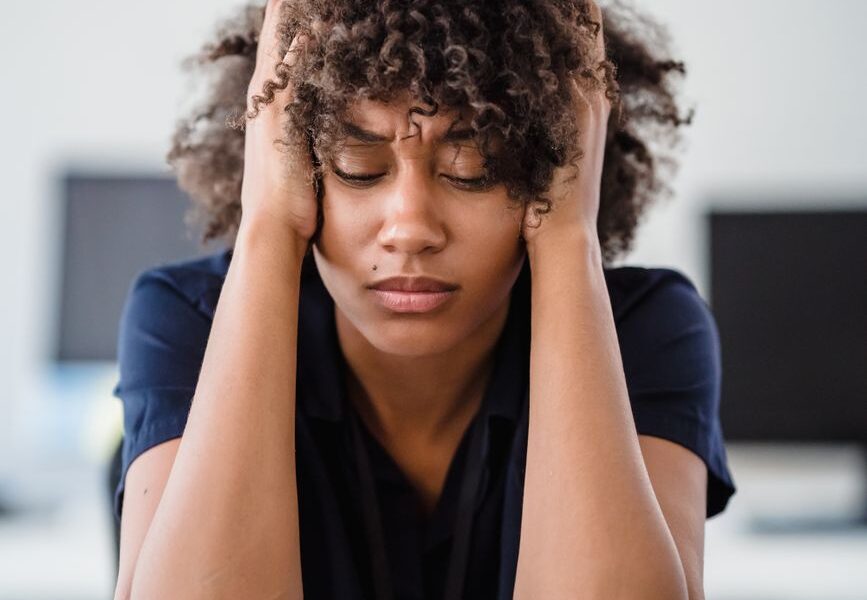 tired woman with hands in hair