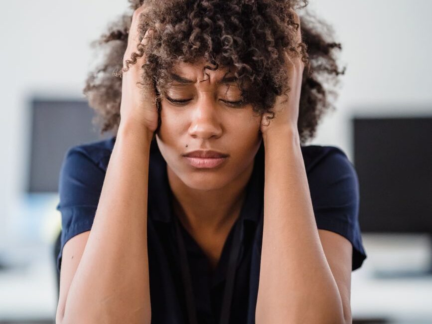 tired woman with hands in hair