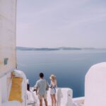 couple walking down the stairs in santorini greece