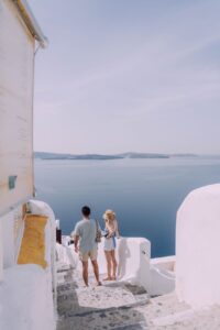 couple walking down the stairs in santorini greece