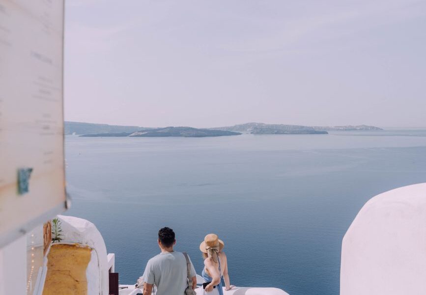 couple walking down the stairs in santorini greece