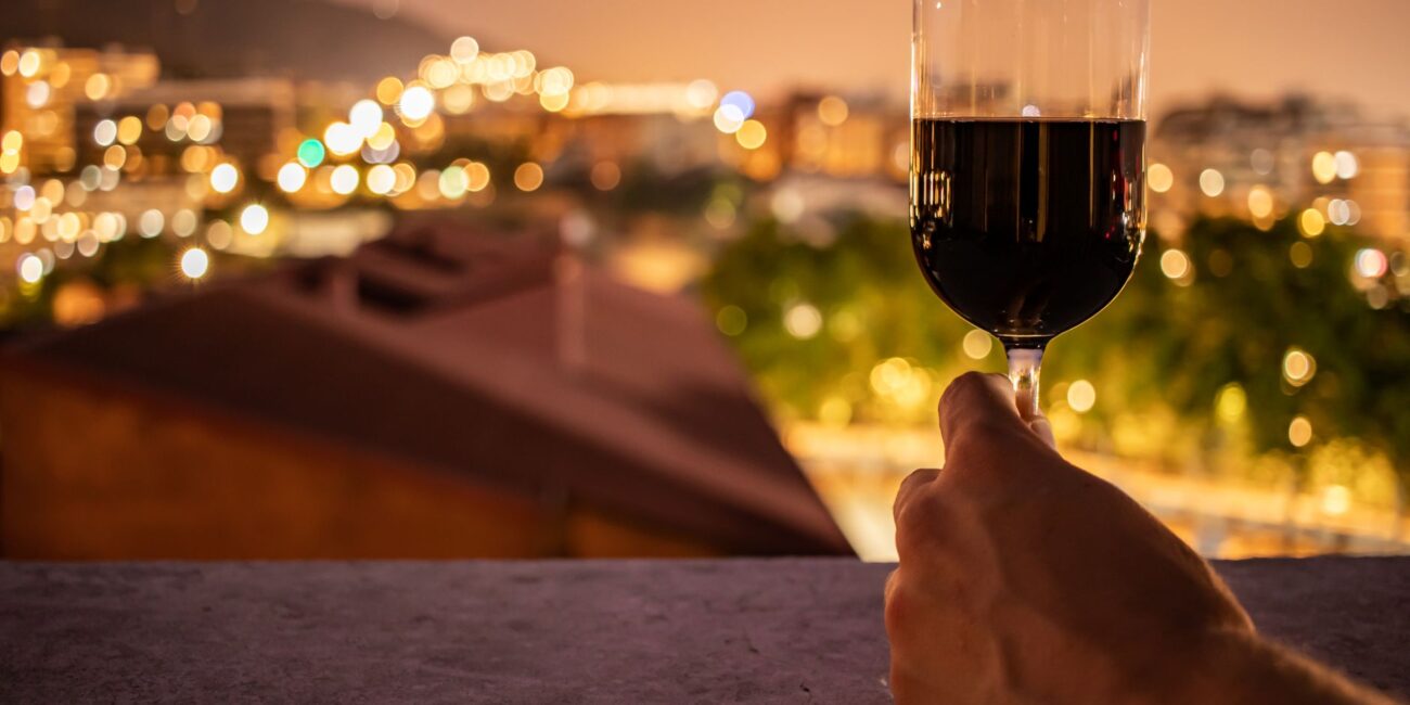 photo of person holding wine bottle