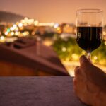 photo of person holding wine bottle