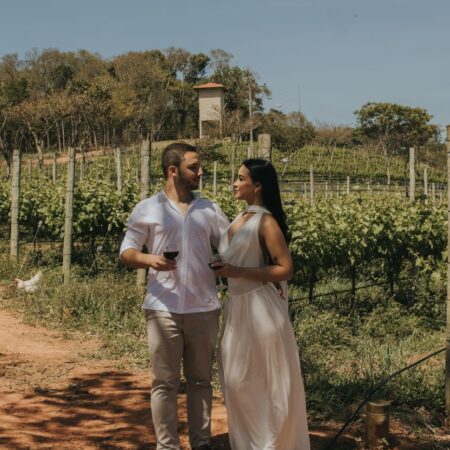 romantic couple enjoying wine in vineyard