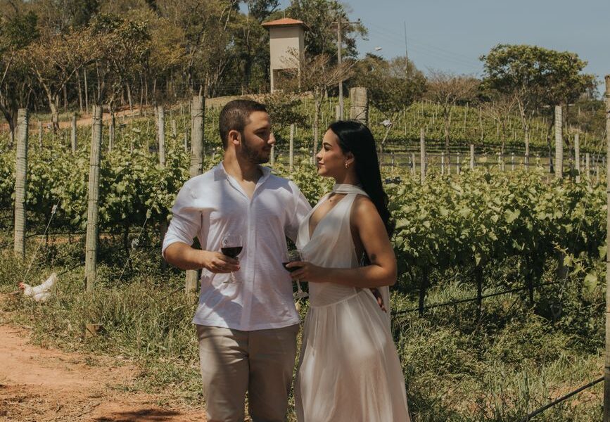 romantic couple enjoying wine in vineyard