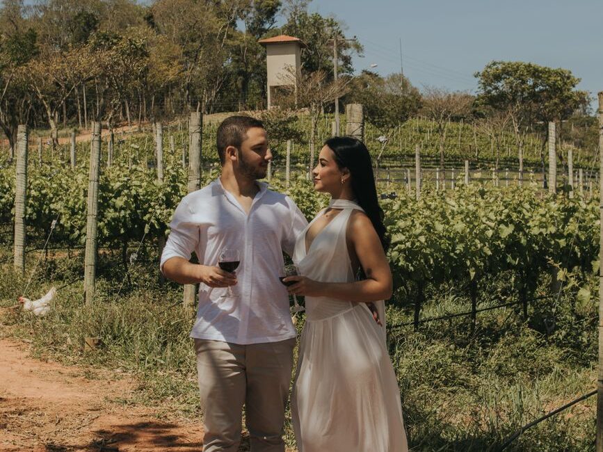 romantic couple enjoying wine in vineyard