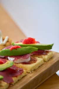 close up of gourmet avocado toasts with toppings