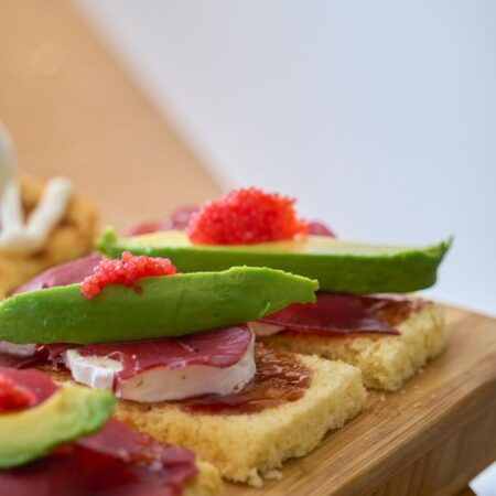 close up of gourmet avocado toasts with toppings
