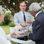 man putting a ring on his bride